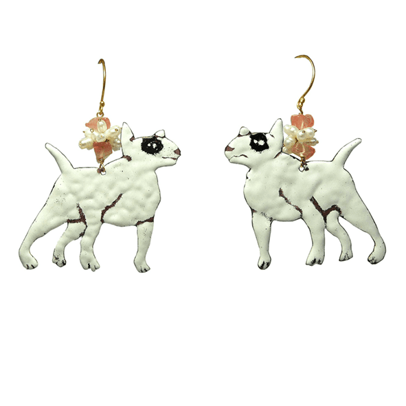 A pair of whimsical earrings shaped like white dogs with black spots, featuring decorative elements like pink and pearl beads.