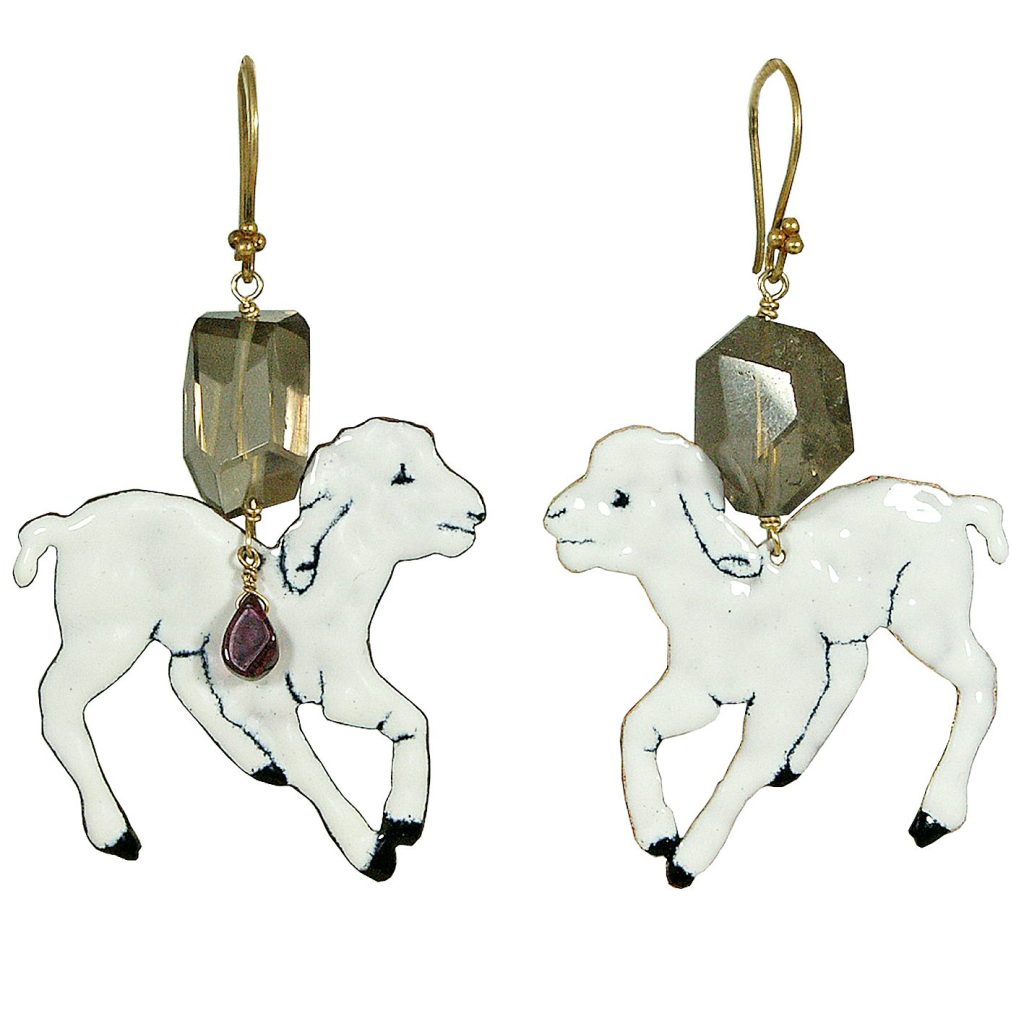 A pair of whimsical earrings featuring two white goat charms, each adorned with a decorative gemstone and gold-colored hooks.