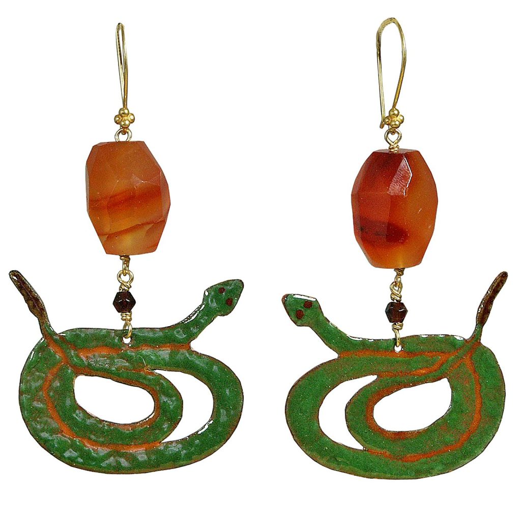 A pair of vintage earrings featuring green snake motifs with red accents, complemented by a large, faceted orange bead at the top.