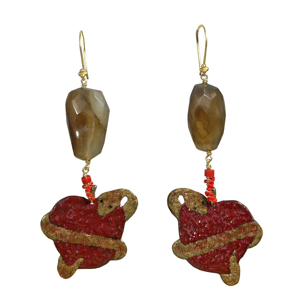 A pair of handmade earrings featuring red heart-shaped pendants with a golden swirl design, adorned with a brown faceted bead and small red beads.